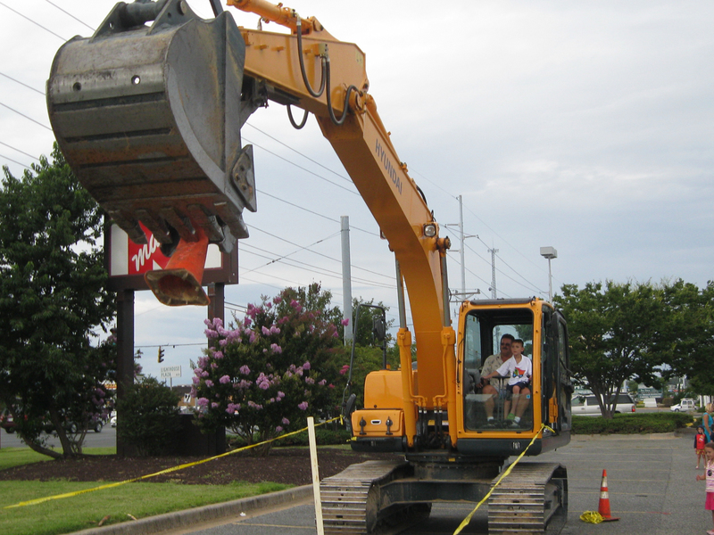 Doug Boozer helps Blake Robinson, 6 of Wilmington, drive a crane. Robinson was able to lift up a traffic cone, wave it around and drop it back to the ground. BY RACHEL SWICK MAVITY